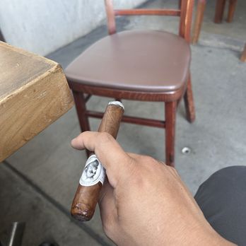 V Cut Cigar Lounge - a hand holding a cigar - Tobacco Shops Near Me - Los Angeles, California V Cut Cigar Lounge - a hand holding a cigar - Tobacco Shops Near Me - Los Angeles, California