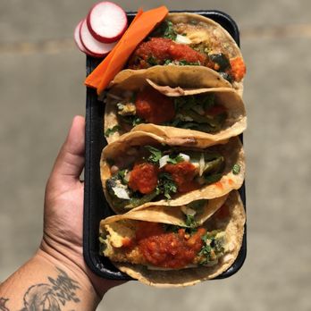 Tacos Estrella - a hand holding a tray of tacos - Food Trucks Near Me Tacos Estrella - a hand holding a tray of tacos - Food Trucks Near Me