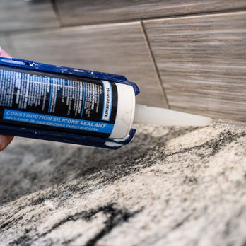 DiFiore Builders - a close up of a person's hand holding a glue gun - General Contractors Near Me - Chadds Ford, Pennsylvania