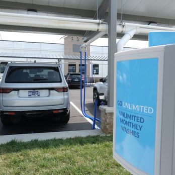 Pure Clean Car Wash - A car is parked in the parking lot of a car wash next to a sign that reads "Go unlimited, unlimited monthly washes." - Car Wash Near Me - Franklin, Tennessee Pure Clean Car Wash - A car is parked in the parking lot of a car wash next to a sign that reads "Go unlimited, unlimited monthly washes." - Car Wash Near Me - Franklin, Tennessee