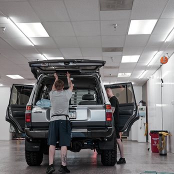 SmartFilm - Carefully removing the third brake light to measure and apply tint to the rear window. - Car Window Tinting Near Me - Tempe, Arizona