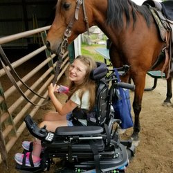 A rider waiting to get on her horse!