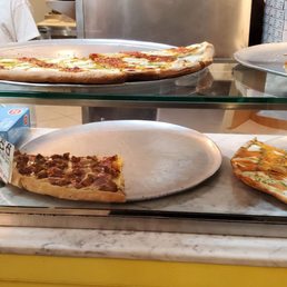 a variety of pizzas on display