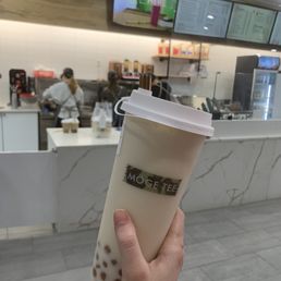 Green Milk Tea  and order counter in background.