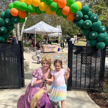 Magically Made - Rapunzel and little girl smile for camera at the entrence of the park - Party Characters Near Me - Pasadena, California