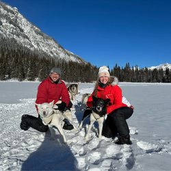Snowy Owl Sled Dog Tours - Us with our dog team at the halfway mark on the frozen lake