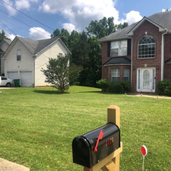 Cooper Cuts - a mailbox in front of a house - Irrigation Near Me