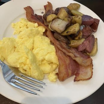 Carries Restaurant - The $12 breakfast (bear in mind they do charge $5.50 for coffee) - A breakfast plate with scrambled eggs, crispy bacon, and roasted potatoes with mushrooms and sausage slices. - Breakfast & Brunch Near Me - Albuquerque, New Mexico