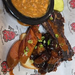 Trio Platter w/ a hot link, 2 spare ribs, burnt ends, piece of toast and a side of BBQ beans Trio Platter w/ a hot link, 2 spare ribs, burnt ends, piece of toast and a side of BBQ beans