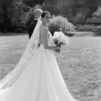 Bethany Picone Photography - The bride glancing back as she is about to walk down the aisle at her Catskills, NY wedding. - Session Photography Near Me