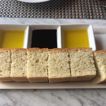 Fig & Olive - Complimentary bread w/ avocado leaf olive oil, 19-year old balsamic, and orange olive oil. - French Near Me - Houston, Texas