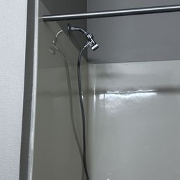 Shower head too high for someone sitting on the bench to reach