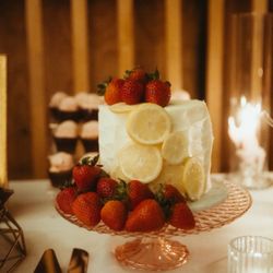 Sugarlips Cakery - Lemon cake w/ strawberry mousse iced w/ vanilla buttercream and fresh strawberries and lemon slices