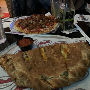 Alberto's Pub and Pizza - Steak bomb calzone and a meat lovers pizza - Italian Near Me - Norton, Massachusetts Alberto's Pub and Pizza - Steak bomb calzone and a meat lovers pizza - Italian Near Me - Norton, Massachusetts