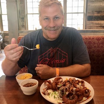 Shepherd's Grill - Hubby enjoying his onion rings. Beans & Mac & cheese on the side. - American Near Me - Branson, Missouri