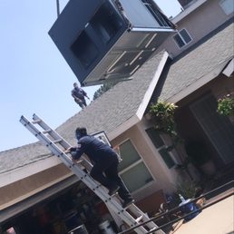 Crane lifting up the new unit. Crane lifting up the new unit.