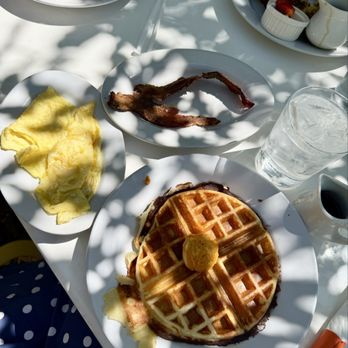 Smothered - Waffle, side bacon and egg recommend putting some of the red chile honey butter on your eggs! - Breakfast & Brunch Near Me - Albuquerque, New Mexico