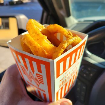 Whataburger - a hand holding a box of fried onion rings - Burgers Near Me - Edmond, Oklahoma