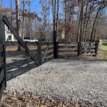 Kingdom Fence Company - a black gate and a gravel driveway - Fences & Gates Near Me Kingdom Fence Company - a black gate and a gravel driveway - Fences & Gates Near Me