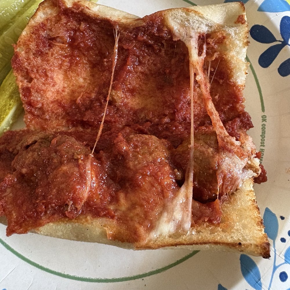 A meatball sub with a dollop of cheese