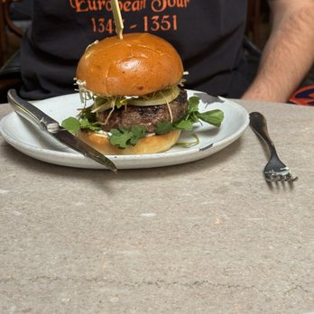 Manuela - Venison Burger, Brioche, Pickled Green Tomato, Crisp Leeks, Roasted Garlic Aioli - New American Near Me - Los Angeles, California Manuela - Venison Burger, Brioche, Pickled Green Tomato, Crisp Leeks, Roasted Garlic Aioli - New American Near Me - Los Angeles, California