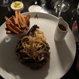 Garlic and thyme infused ribeye, topped with fried onion strings. Accompanied with great house fries and peppercorn sauce. Garlic and thyme infused ribeye, topped with fried onion strings. Accompanied with great house fries and peppercorn sauce.
