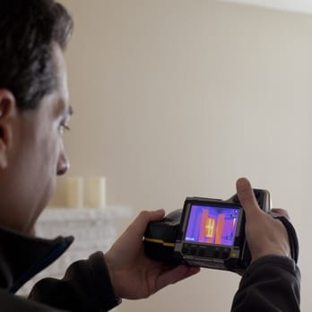 Simplicity Home Energy - Bob Greenspun using an infrared camera to see air leaks - Home Energy Auditors Near Me Simplicity Home Energy - Bob Greenspun using an infrared camera to see air leaks - Home Energy Auditors Near Me