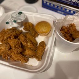a tray of fried chicken and a cup of coffee
