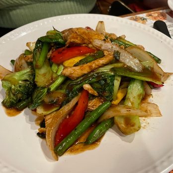 Imm Thai - A stir-fried vegetable dish with chicken, including broccoli, bell peppers, onions, and green beans, served on a white plate. - Thai Near Me - Clark, New Jersey