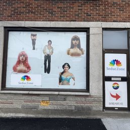 Exterior outside entrance of SeducZone/ Boutique LGBT - Left side of the shop, showing store sign and promotional design - Montreal, Quebec Exterior outside entrance of SeducZone/ Boutique LGBT - Left side of the shop, showing store sign and promotional design - Montreal, Quebec