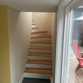 Alpha Wolf Construction - AFTER: View of stairs from lower floor where Alpha Wolf Construction also installed the sliding glass door to the deck and backyard. - General Contractors Near Me - Snohomish, Washington Alpha Wolf Construction - AFTER: View of stairs from lower floor where Alpha Wolf Construction also installed the sliding glass door to the deck and backyard. - General Contractors Near Me - Snohomish, Washington