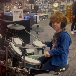 Bennett, trying out the drums. Bennett, trying out the drums.
