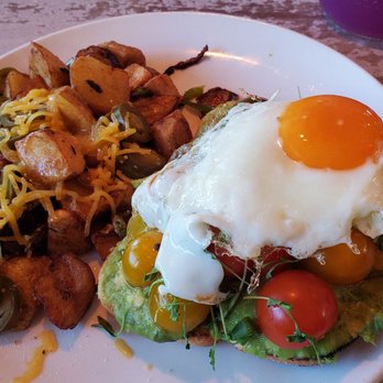 Toast Kitchen & Bar - Cali avo toast with country potatoes & jalapeños w/ cheese. I also added a sunny egg to put on top of the toast. - Breakfast & Brunch Near Me - Brea, California