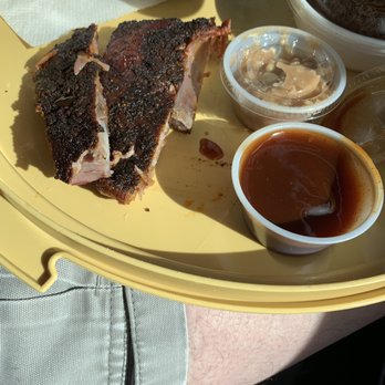 Leland Smoke House - Two ribs next to the small BBQ sauce and cinnamon butter cups. - Barbeque Near Me - Leland, North Carolina Leland Smoke House - Two ribs next to the small BBQ sauce and cinnamon butter cups. - Barbeque Near Me - Leland, North Carolina