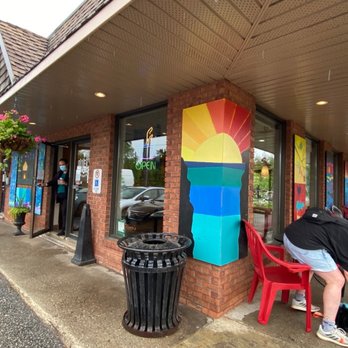 Oliver's Coffee - a person leaning against a building - Coffee & Tea Near Me - Gravenhurst, Ontario