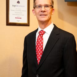 Nashua Oral Surgery Associates - Dr. Trowbridge in our Nashua waiting room beside his "New Hampshire Magazine Best Dentist" plaque.