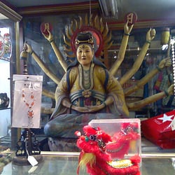 One of the old wooden statues behind the counter in the shop