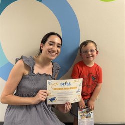 Bliss Speech and Hearing Services - Allison ( a Bliss SLP) celebrating the graduation of one of her patients for completing speech therapy!