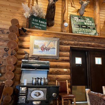 320 Guest Ranch - a wood burning stove in a log cabin - Guest Houses Near Me - Gallatin Gateway, Montana