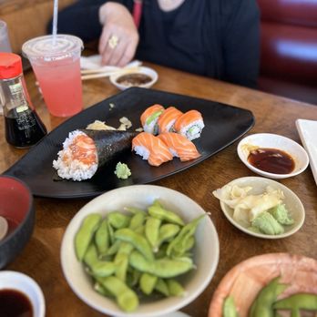 Hanamichi - Salmon nigiri and a salmon hand roll paired with edamame, wasabi, and soy sauce, highlighting clean presentation and fresh ingredients - Sushi Bars Near Me - National City, California Hanamichi - Salmon nigiri and a salmon hand roll paired with edamame, wasabi, and soy sauce, highlighting clean presentation and fresh ingredients - Sushi Bars Near Me - National City, California