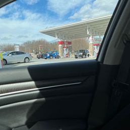 a view of a gas station from inside a car