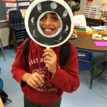 River Oaks Elementary School - A kid showing the moon phases in class - Elementary Schools Near Me - Woodbridge, Virginia