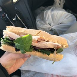 a person holding a sandwich a person holding a sandwich