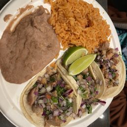 Three Chicken tacos, rice and refried beans. Three Chicken tacos, rice and refried beans.