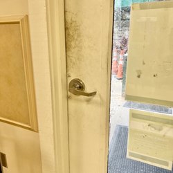 Tallahassee Memorial Urgent Care Center - Dirty floors, doors, glass, plexiglass partitions, bottom portion/side of exam table