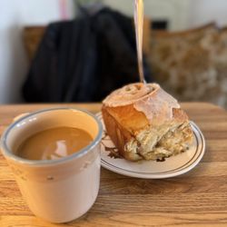 Grumpy's Cafe - Cup coffee and orange cardamom roll