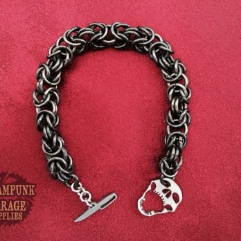Advanced Laser & WaterJet Cutting - Skull and Cutlass used as a bracelet clasp. - Metal Fabricators Near Me - Fremont, California Advanced Laser & WaterJet Cutting - Skull and Cutlass used as a bracelet clasp. - Metal Fabricators Near Me - Fremont, California