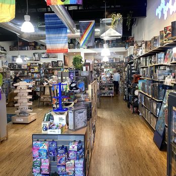 Play Forge - A basic view of the interior. Much larger than it looks. - A retail space filled with shelves of board games, puzzles, and toys, with customers browsing and a wooden floor. - Makerspaces Near Me - Littleton, Colorado