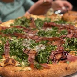 Pino's Place - Pizza!  Burrata, prosciutto, arugula, and balsamic reduction.  Tasty, perfect crust, and worth it.  Yes.