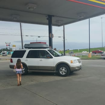 Pilot - a woman standing in front of a white suv - Gas Stations Near Me - Hammond, Louisiana
